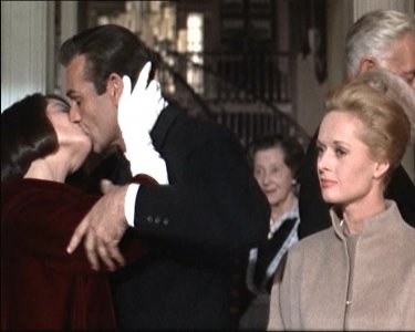 Diane Baker bacia Sean Connery sotto gli occhi di Tippi Hedren in una scena del film Marnie