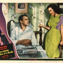 Joseph Cotten e Teresa Wright in una coloratissima lobbycard promozionale del film L'ombra del dubbio ( 1943 )