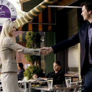Tom Welling stringe la mano ad Emilie Ullerup in una scena dell'episodio Crossfire di Smallville