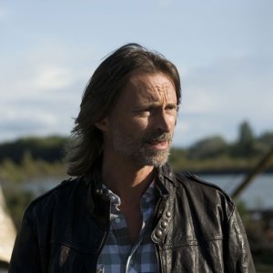 Il Dott. Rush (Robert Carlyle) sulla Terra nell'episodio Subversion di Stargate Universe
