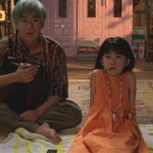 Ryu guarda la televisione con la sorellina in una scena di Mr. Vendetta