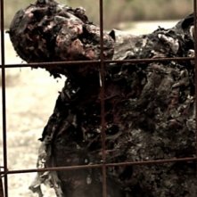 Uno zombie in azione tenta di attraversare la recinzione in Eaters