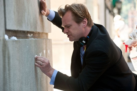 Christopher Nolan draws something on the wall of the set of The Dark Knight Rises