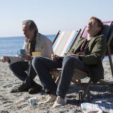 Questione di tempo: Domhnall Gleeson insieme a Bill Nighy in spiaggia in una scena del film