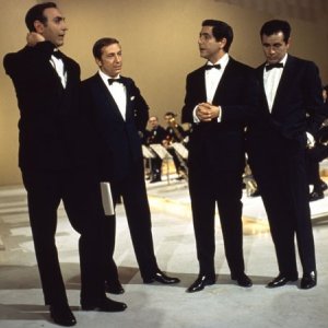 Quattro icone della televisione italiana: Mike Bongiorno, Corrado, Pippo Baudo ed Enzo Tortora.