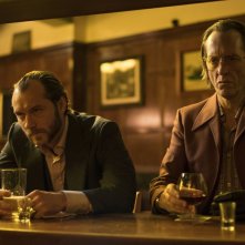 Dom Hemingway: Jude Law insieme a Richard E. Grant al bar in una scena 