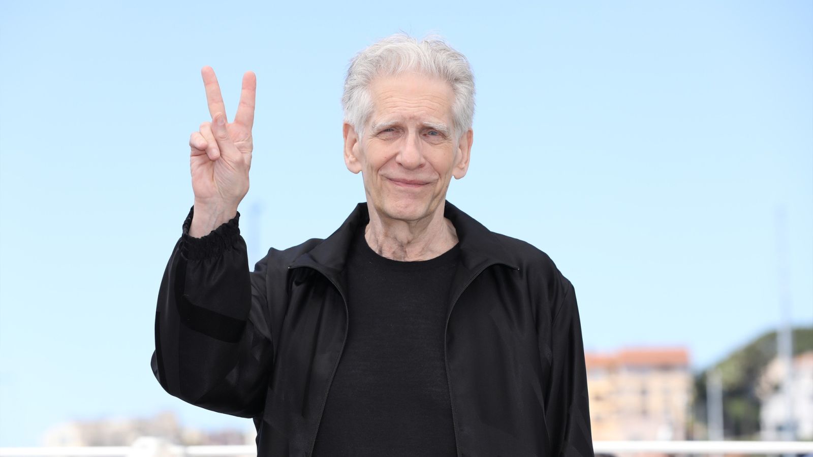 David Cronenberg fa il segno della vittoria a Cannes 2024